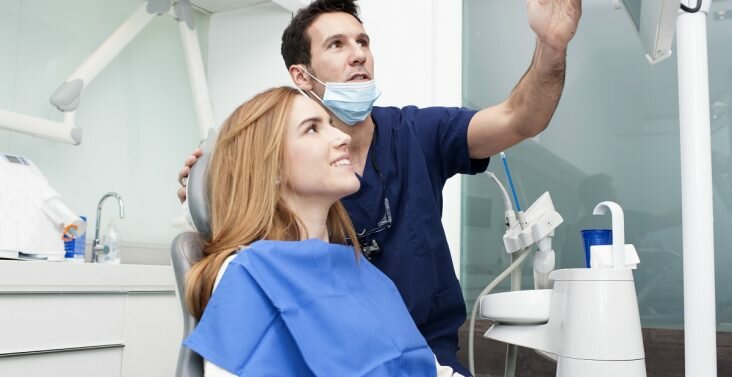 Dentist discussing to a patient